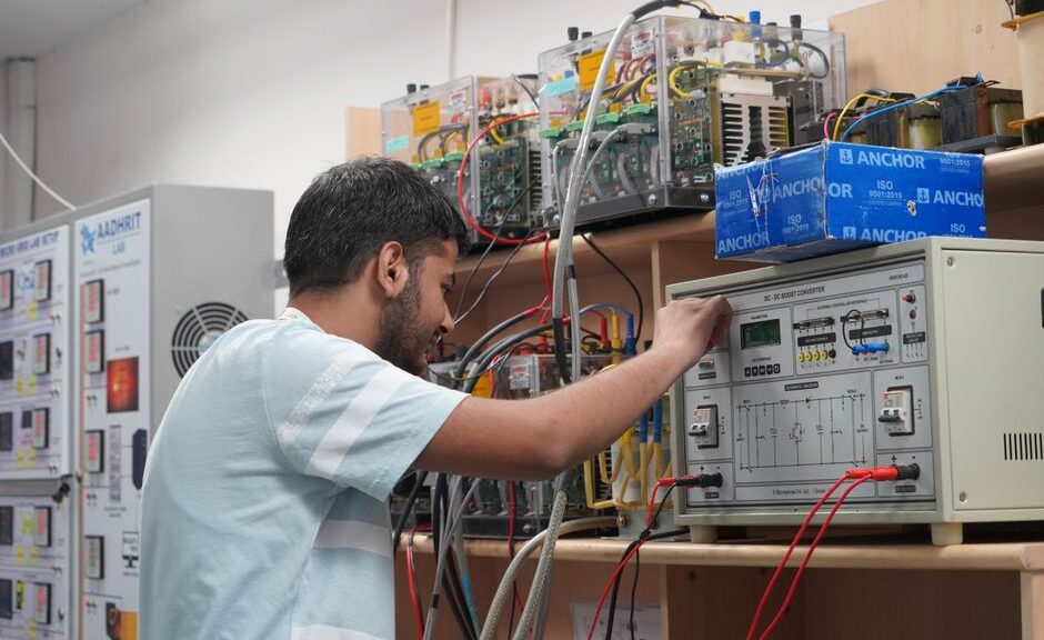 Engineer adjusting equipment in an advanced research lab setting.