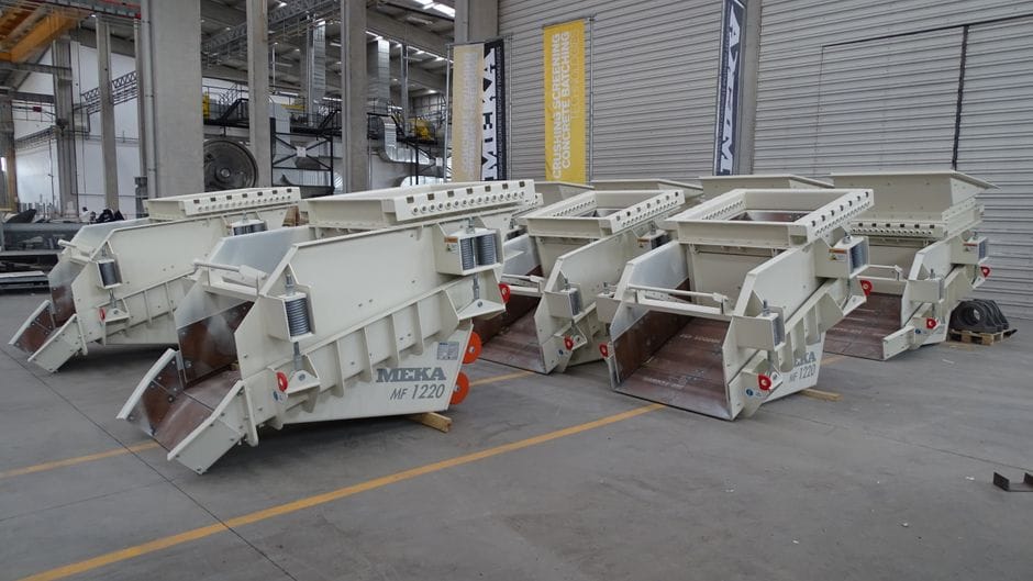 Row of heavy-duty industrial machinery inside modern factory facility.